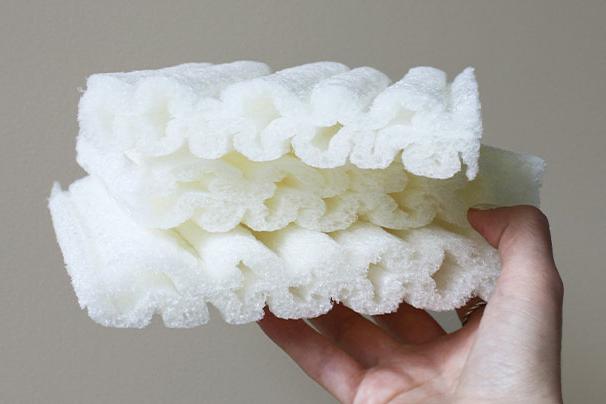 hand holding pieces of biodegradable foam